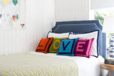 09 The kids’ room is airy and light-colored, and bold shades are brought with pillows
