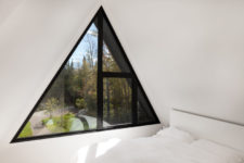 09 The master bedroom is pure white, with a pretty triangle window and a comfy bed