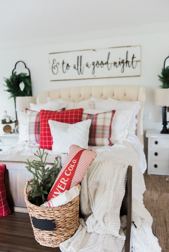 a wicker basket, some red and plaid touches and neutral bedding for a cozy farmhouse bedroom