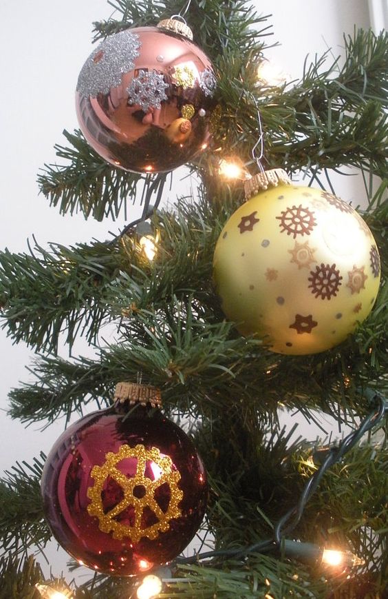 make some steampunk ornaments painting gears on baubles with glitter or contrasting paint