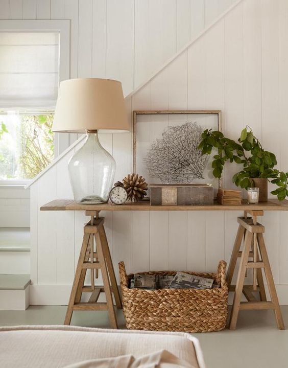a simple wooden trestle console plus a woven basket for a farmhouse interior