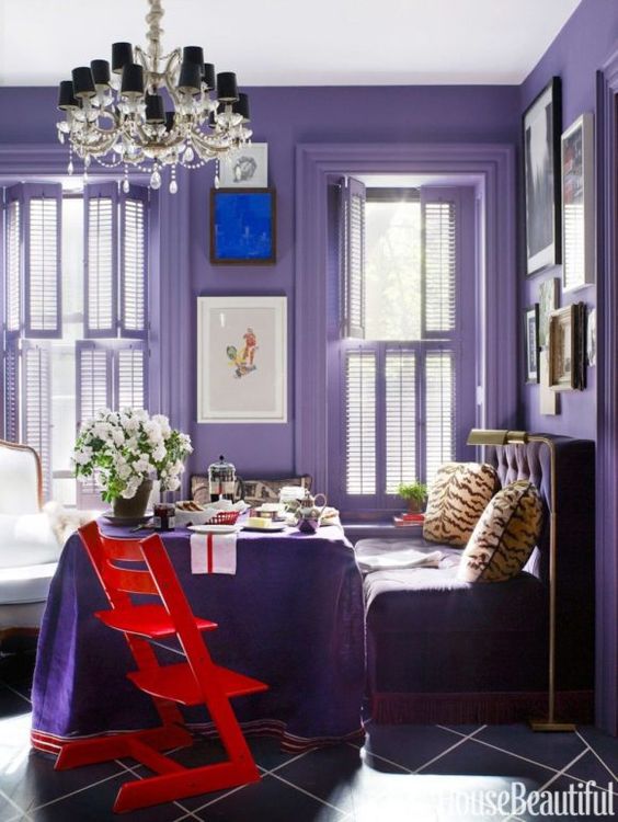 an ultra violet breakfast space with violet walls, furniture and a table