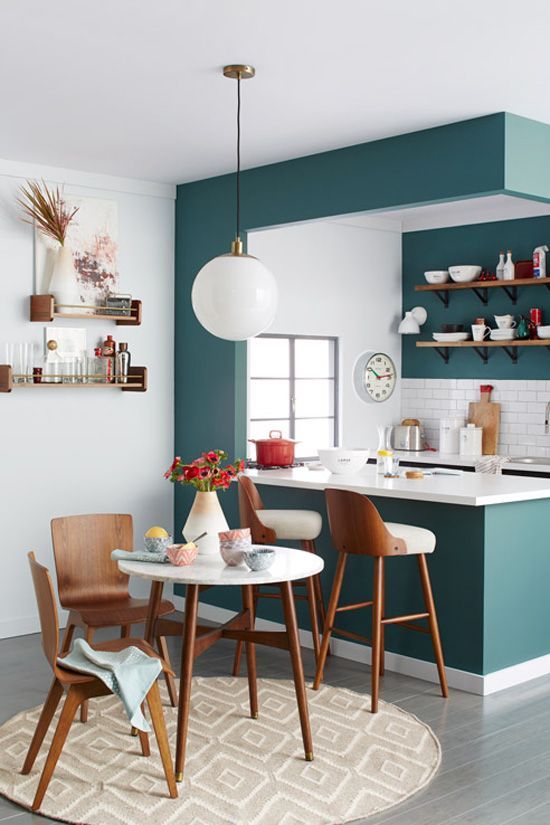 a teal kitchen with white and natural wood touches is perfectly retro styled