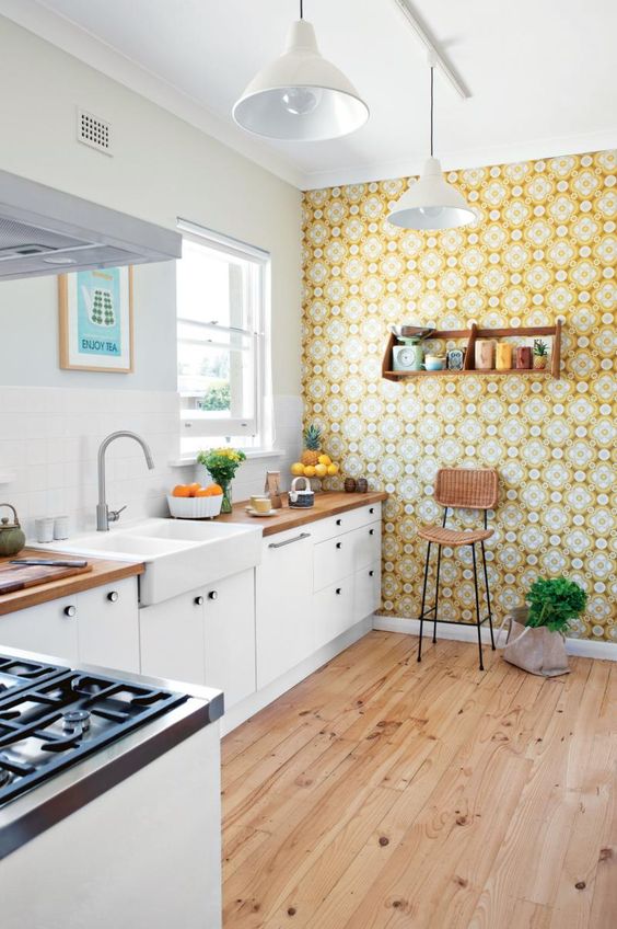a bold printed wallpaper accent wall is a great idea to add a retro feel to your kitchen