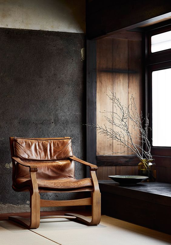 A fantastic leather chair with a wooden frame of an interesting shape looks very eye catching
