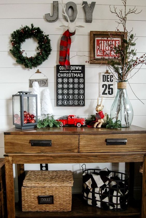 a lantern with red ornaments, vintage Christmas toys and a lit up wreath on the wall
