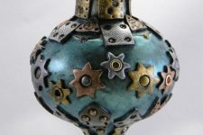 12 a metal Christmas ornament with metal stars, gears, grommets and other details