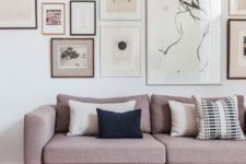 13 a modern living room with a whole gallery wall over the dusty pink sofa