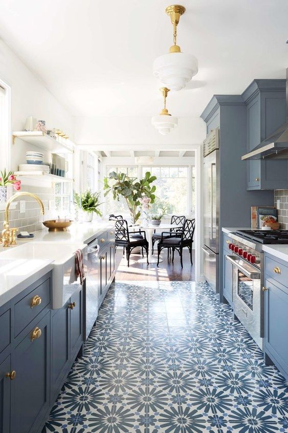 a pretty patterned tile floor that matches the cabinets in its colors