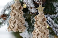 13 burlap Christmas tree ornaments with neutral buttons and glitter stars on top