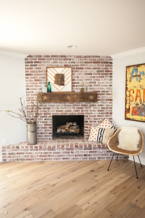a custom brick fireplace with antique white mortar and custom reclaimed barn wood mantel