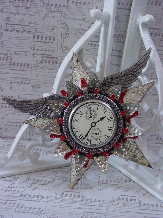 a steampunk decoration with wings, stars, a clock and some glitter touches