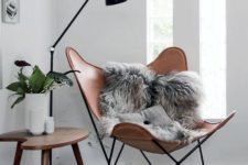 14 a very chic leather chair with faux fur and a Scandinavian floor lamp for a stylish reading nook