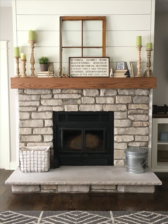 a natural stone fireplace with a wooden mantel looks very rustic, and you may add some rustic details