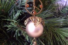 15 a steampunk ornament with beads, gears and a pink bauble