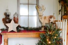 15 an old window, jars with pinecones and candies, wooden decor and some evergreen trees in a crate for a rustic look