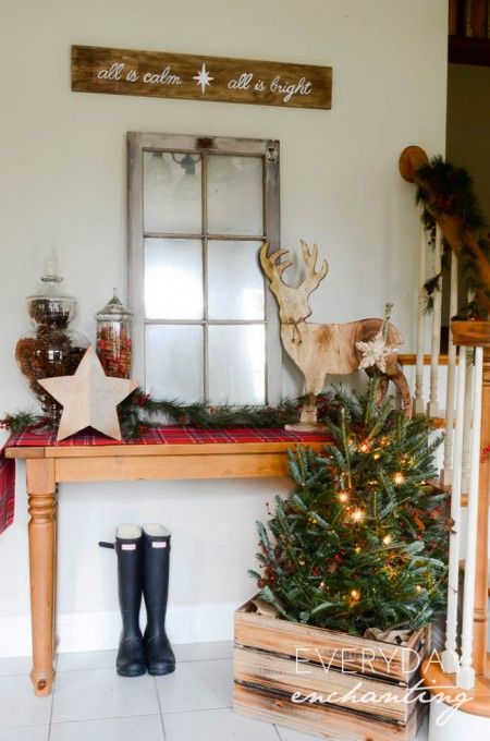 an old window, jars with pinecones and candies, wooden decor and some evergreen trees in a crate for a rustic look