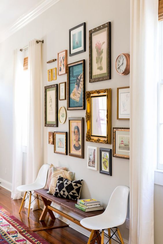 A vintage inspired gallery wall with mismatching frames of various sizes and looks