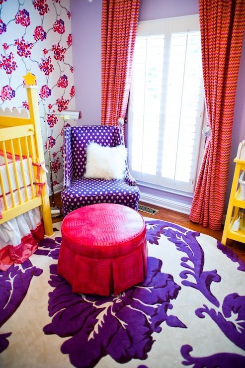 a violet polka dot chair in the nursery and a violet and white floral print rug