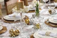 17 a holiday tablescape with gold and silver ornaments, wicker chargers, glitter candles and white blooms