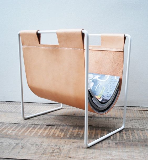 a brown leather magazine rack is a chic and elegant piece for any interior