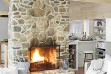 18 a gorgeous stone fireplace in light shades with a metal cover looks very genuine