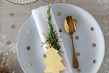 18 a lace tablecloth, gold ornaments, a wooden tree napkin tag and evergreens for a cute tablescape