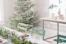 18 a modern table setting with a foliage garland and large gingerbread men cookies for a cool look