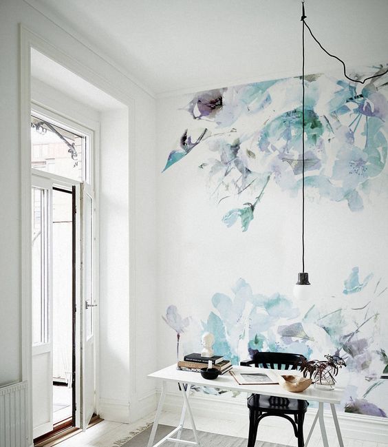 an airy girl's workspace and an accent wall done with watercolor floral wallpaper