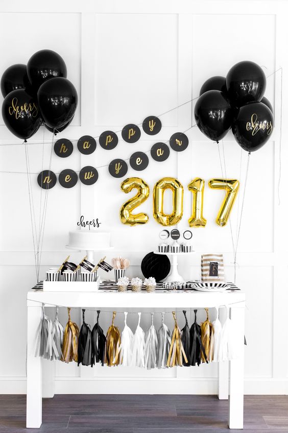 gold number balloons and black balloons with gold calligraphy for decorating a dessert table