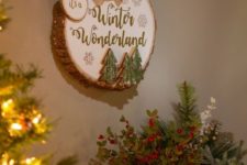 19 a winter sign with a large burlap bow, Christmas trees attached, snowflakes and calligraphy