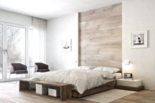 19 white walls are spruced up with a wood clad headboard and matching floors