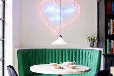 20 a chic retro diner breakfast nook with a neon sign, an emerald sofa and printed chairs
