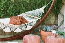 20 add an exotic feel to your outdoor space with a hammock and a couple of leather Moroccan-styled poufs