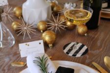 21 a sparkly tablescape with glitter ornaments, tulips, evergreens and black and white touches