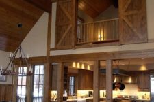 22 a real barn home with light-colored wood on the floor, ceiling and barn doors
