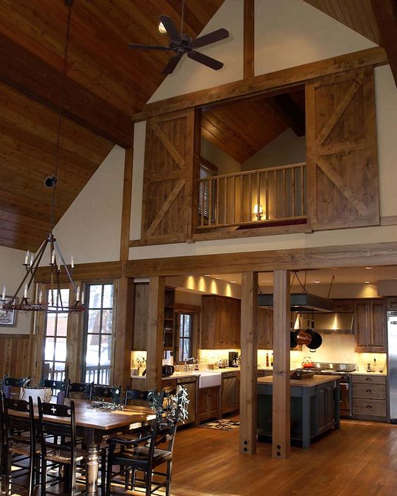 A real barn home with light colored wood on the floor, ceiling and barn doors