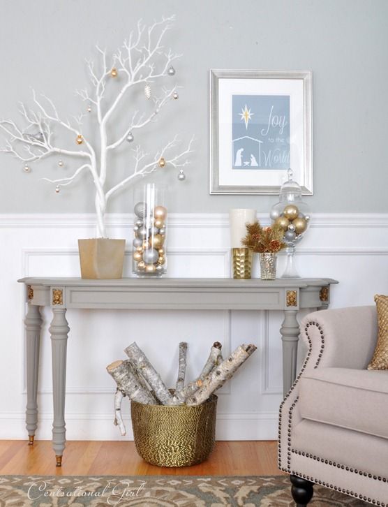 ornaments in jars, a white tree with metallic ornaments and a metallic basket with branches