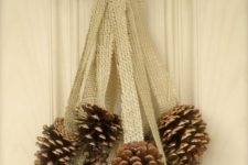 23 a burlap and pinecone door decoration can be hung on a door, mantel or railing