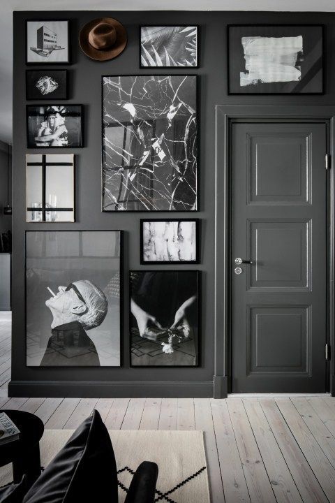 a grey space with a black and white gallery wall that takes the whole grey wall