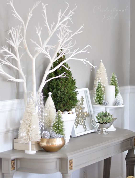 Christmas trees, ornaments, a succulent and candles for snowy styling