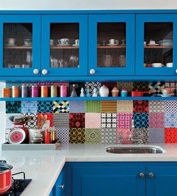 a bold blue kitchen with super colorful tiles of all kinds but the same size