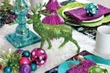24 a colorful tablescape with ornaments, napkins and chargers of different colors and a glitter deer