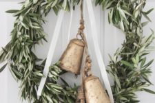 24 a greenery wreath with a ribbon bow and large vintage bells will make your space farmhouse like at once
