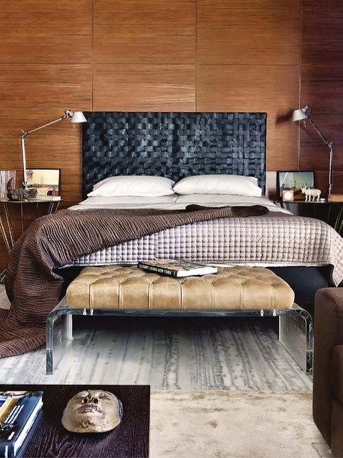 warm wood walls contrast a black leather woven headboard that brings texture in