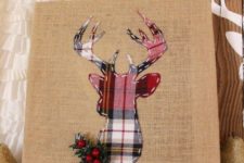 25 a burlap sign with a plaid deer, faux greenery and berries looks rustic and creative