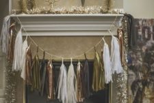 25 a metallic tassel garland over the fireplace and tinsel garlands