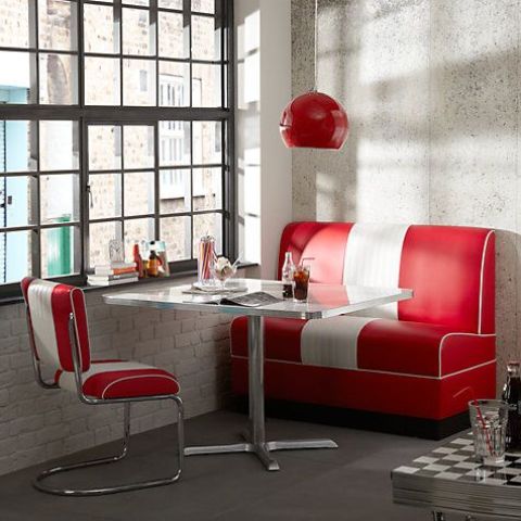 a fun industrial retro dining space with a striped sofa and chair and a metal table