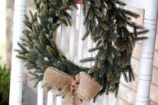 26 an evergreen wreath with checked ribbon and a burlap bow