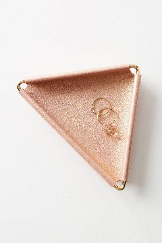 a triangle blush leather trinket dish with brass metal is a chic idea for any girl's space
